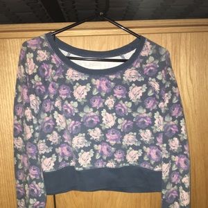 A purple cropped floral sweater.